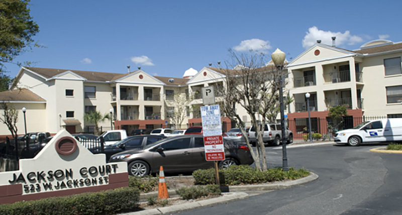 A multi-story Jackson Court building and its property sign.