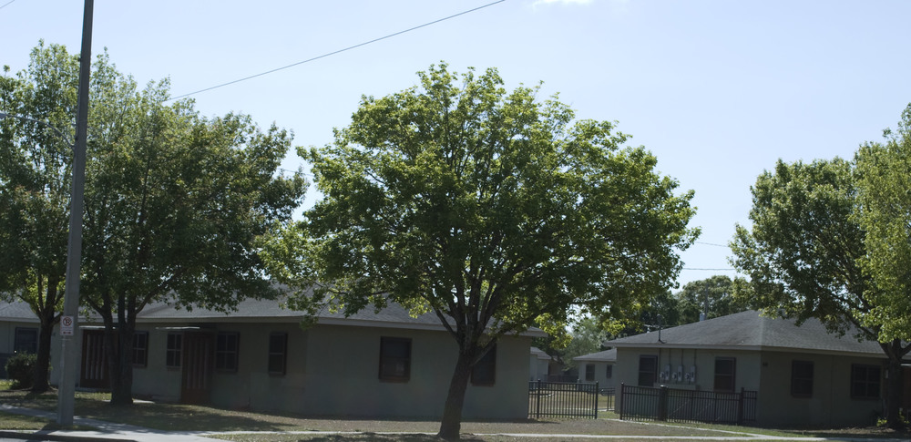 Several Lake Mann Homes buildings surrounded by trees.