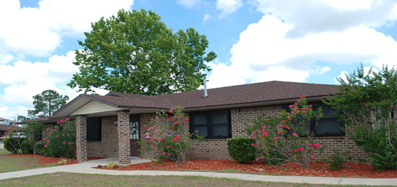 The front of a brick building at Marden Meadows Apartments.